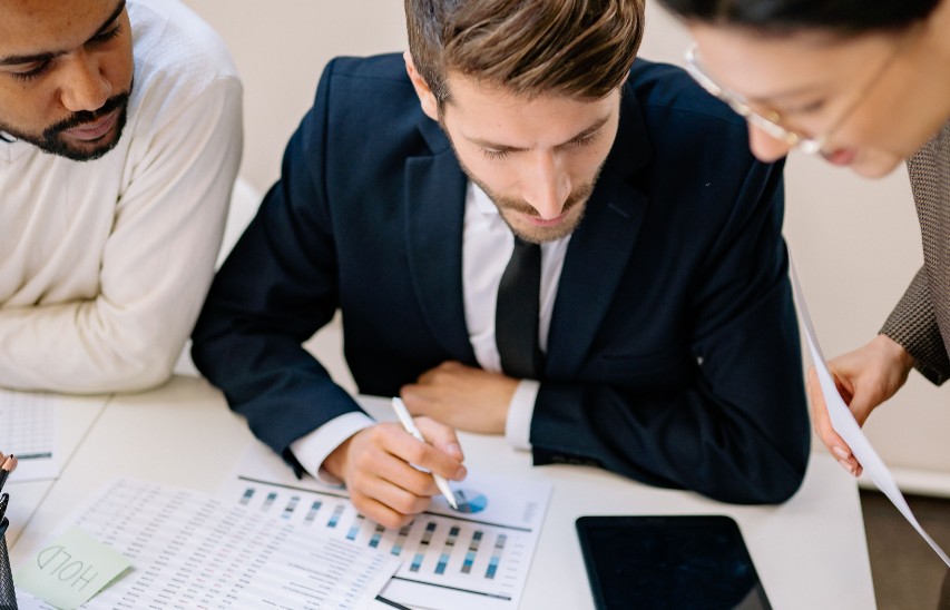 Business team reviewing financial data and growth plans to manage VAT and compliance risks