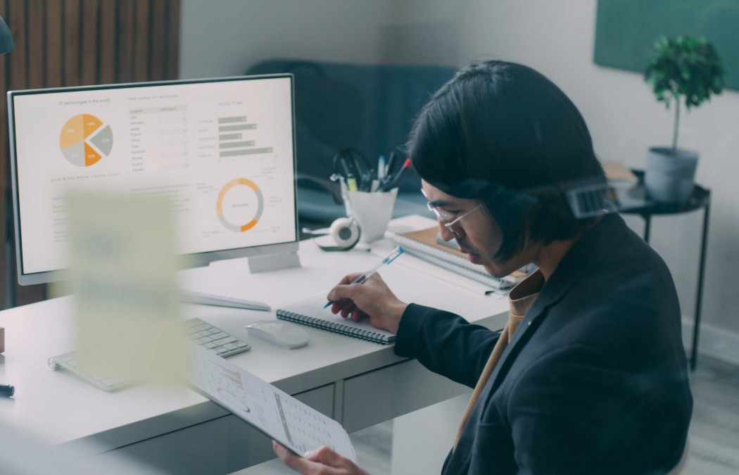 Professional reviewing financial reports and business performance data during a financial due diligence review.