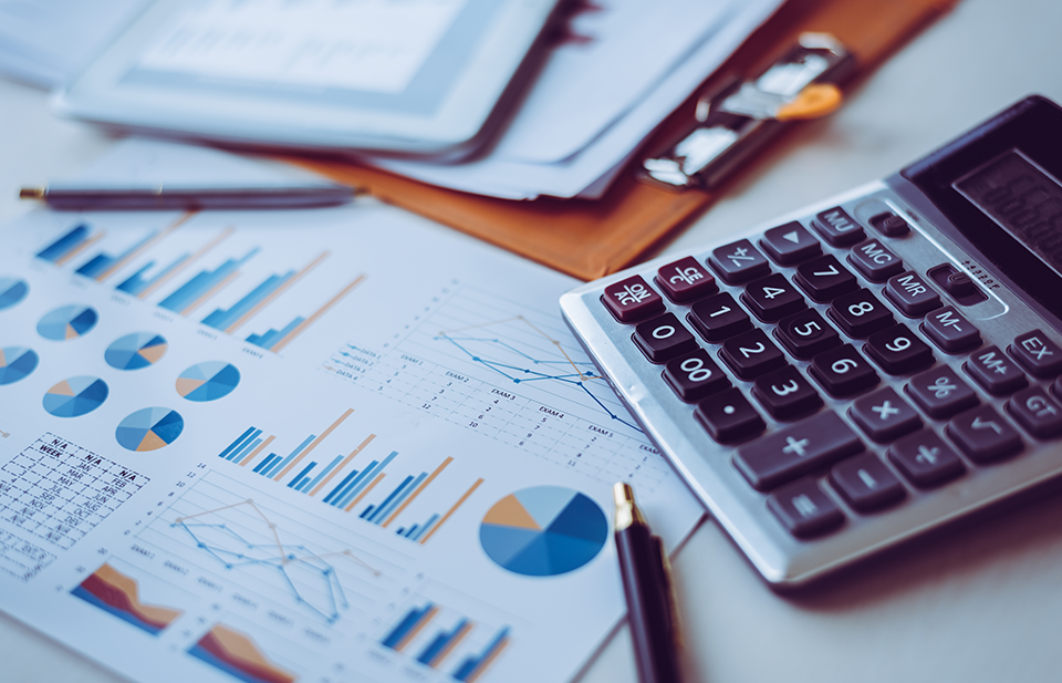 Calculator, pen, clipboard and business forecast with graphs