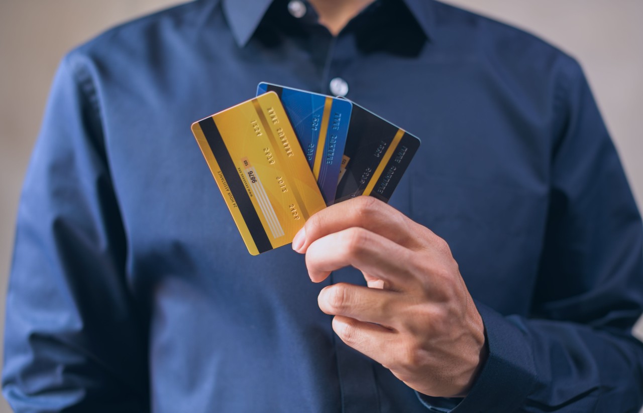Person holding several credit cards to illustrate business credit and borrowing